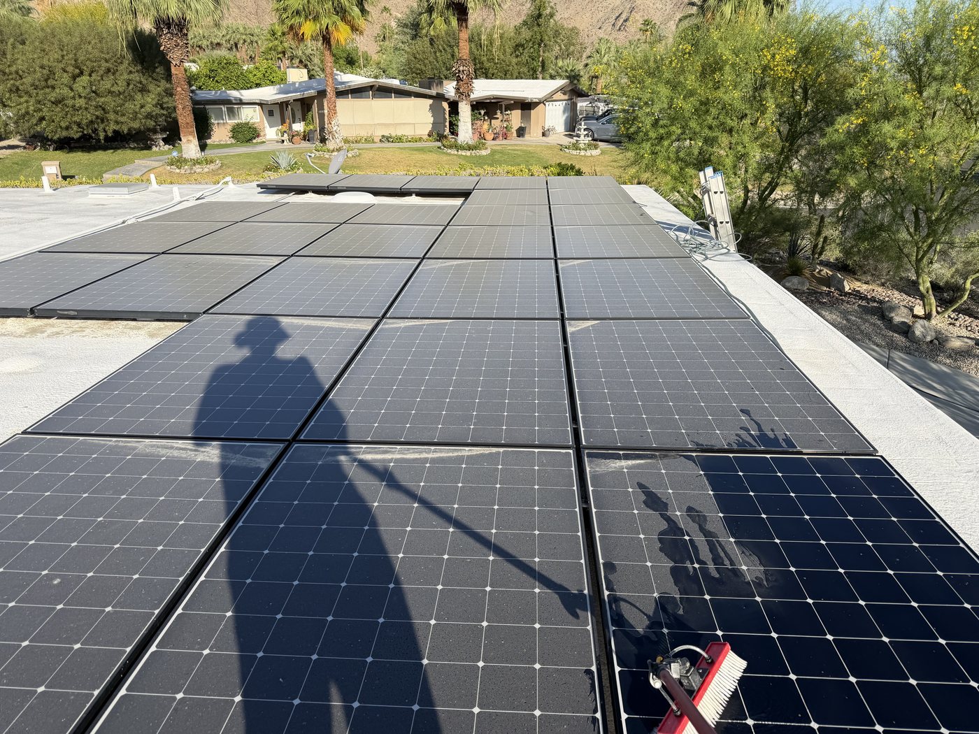 Dusty solar panels on a desert home roof before cleaning